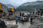 Members of Indian Army try to recover trucks buried at the area affected by flood in Sikkim 