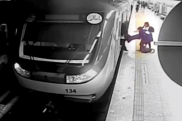 In this image from surveillance video aired by Iranian state television, women pull 16-year-old Armita Geravand from a train car on the Tehran Metro in Tehran, Iran, Oct. 1, 2023. 