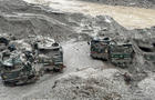 FILE PHOTO: Trucks buried in mud are seen in an area affected by flood in Sikkim 