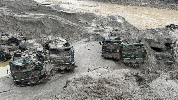 FILE PHOTO: Trucks buried in mud are seen in an area affected by flood in Sikkim