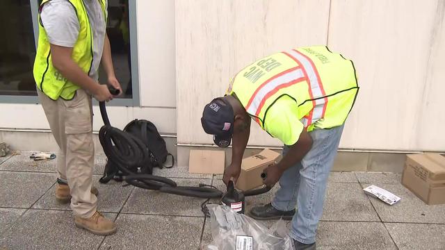 Workers in neon yellow work vests install a rain water pump. 