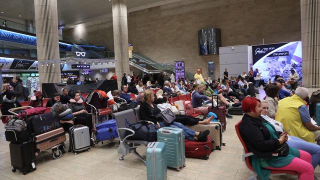 Passengers wait at Ben Gurion Airport near Tel Aviv, Israel, on October 7, 2023, as flights are canceled because of the Hamas surprise attack. 
