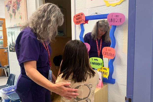 Nurse Jodi Bobbitt helps a child at school 