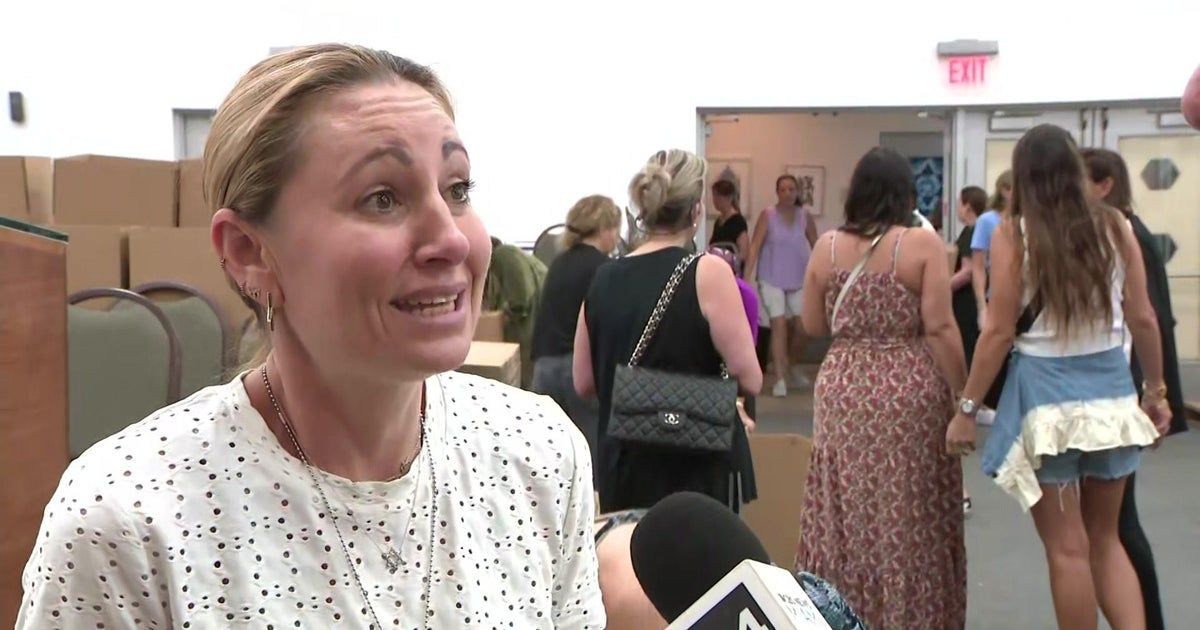 Volunteers converse out as they pack, ship materials to Israel Volunteers converse out as they pack, ship materials to Israel