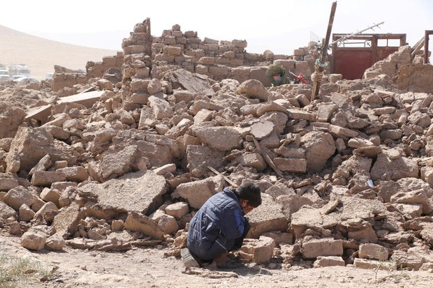 A boy cries as he sits next to debris in the aftermath of an earthquake in Zinda Jan, Afghanistan, Oct. 8, 2023.