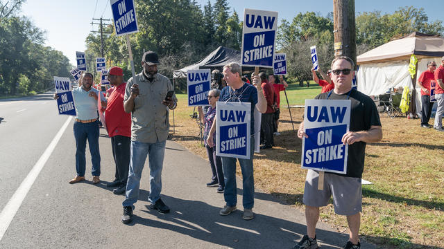 UAW (United Auto Workers) members on the picket line while 