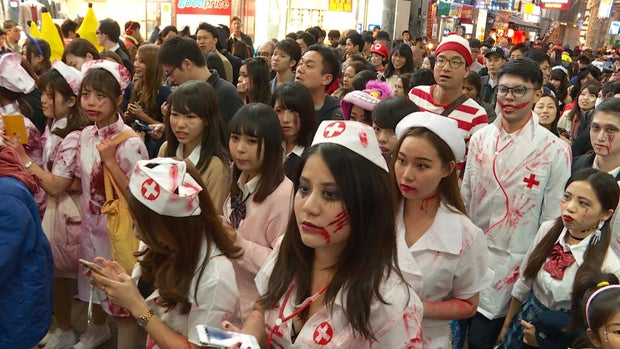 Costumed partiers crowd a street in Shibuya in 2015
