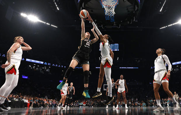 Sabrina Ionescu #20 of the New York Liberty drives to the basket and is blocked by A'ja Wilson #22 of the Las Vegas Aces in the first half during Game Four of the 2023 WNBA Finals at Barclays Center on October 18, 2023 in New York City. 