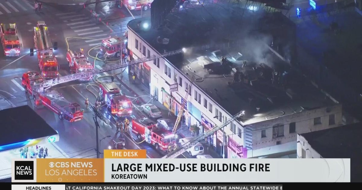 Firefighters work to put out flames in an early morning mixedused building fire in Koreatown