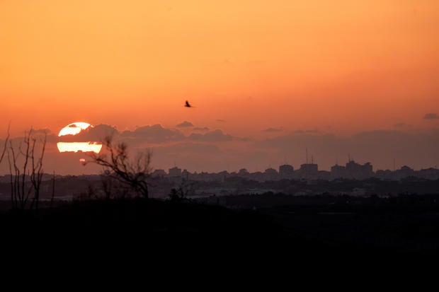 The sun sets over the Gaza Strip as seen from the Israeli side of the border, in southern Israel, Oct. 20, 2023. 