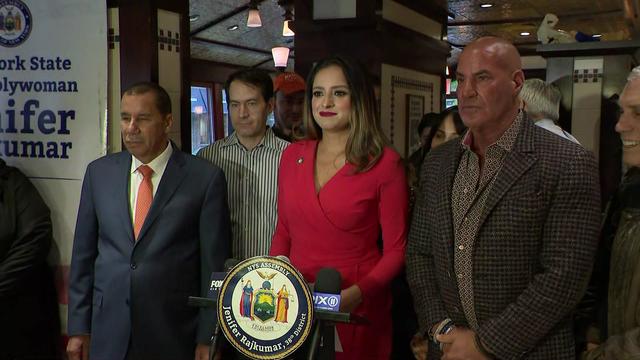 New York State Assemblymember Jenifer Rajkumar and others stand inside the Second Avenue Deli. 