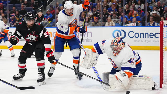 Semyon Varlamov #40 and Ryan Pulock #6 of the New York Islanders battle against Alex Tuch #89 of the Buffalo Sabres for a rebound during an NHL game on October 21, 2023 at KeyBank Center in Buffalo, New York. 