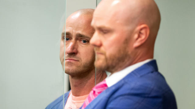 Joseph David Emerson, left, an off-duty pilot who was riding in the cockpit jump seat on an Alaska Airlines flight and was accused of trying to disable the plane's engines, appears with his attorney in Multnomah County court in Portland, Oregon, Oct. 24, 