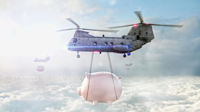 Helicopters carrying piggy banks over clouds 