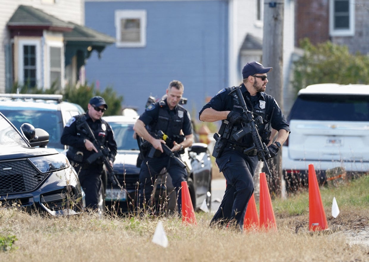Members of law enforcement arrive at a farm in Lisbon Falls, Maine, as the search for the suspect in the deadly mass shooting in Lewiston continues, Oct. 27, 2023. 