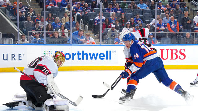 Bo Horvat #14 of the New York Islanders attempts a shot against Joonas Korpisalo #70 of the Ottawa Senators as Thomas Chabot #72 defends during the first period at UBS Arena on October 26, 2023 in Elmont, New York. 