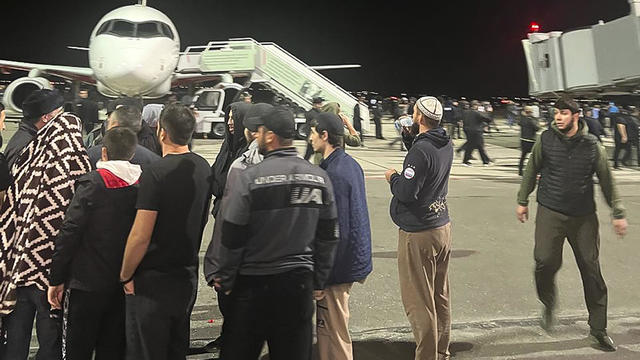 People in the crowd walk shouting antisemitic slogans at an airfield in Makhachkala, Russia, Monday, Oct. 30, 2023. 
