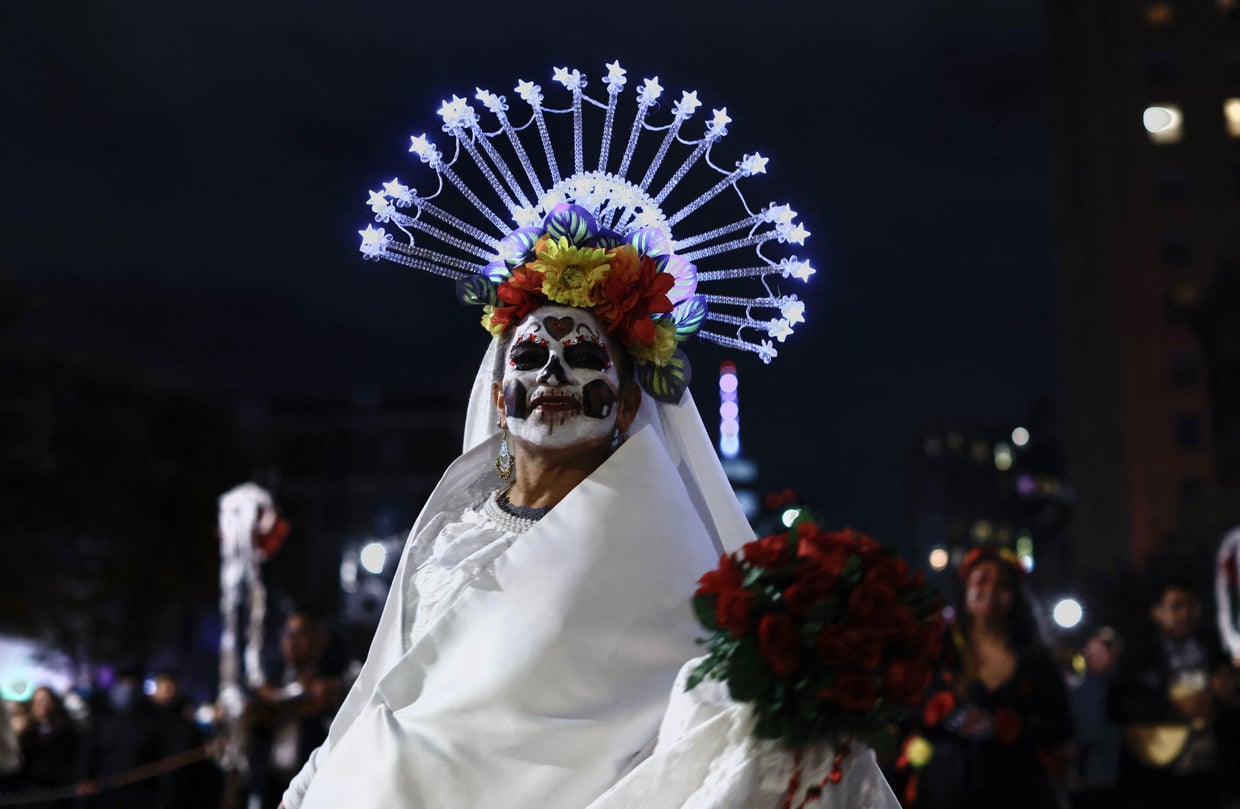 A woman dressed as La Catrina attends the Annual Village Halloween parade in New York on October 31, 2023.