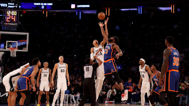 Victor Wembanyama #1 of the San Antonio Spurs and Mitchell Robinson #23 of the New York Knicks jump for the ball to start the game at Madison Square Garden on November 08, 2023 in New York City. 