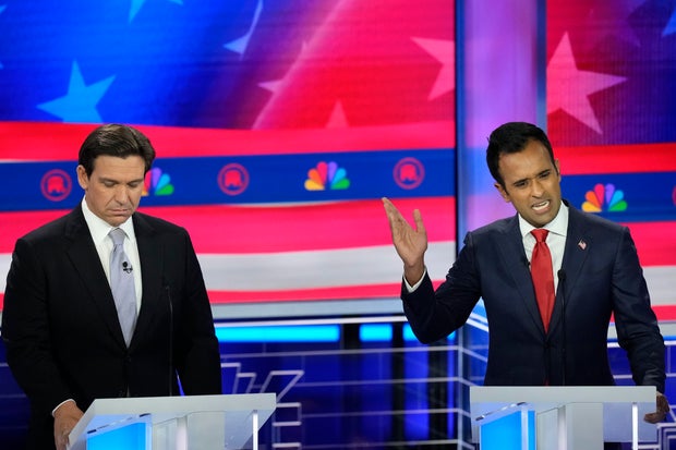 Republican presidential candidate businessman Vivek Ramaswamy speaks as Florida Gov. Ron DeSantis listens during a debate hosted by NBC News on Nov. 8, 2023, in Miami.