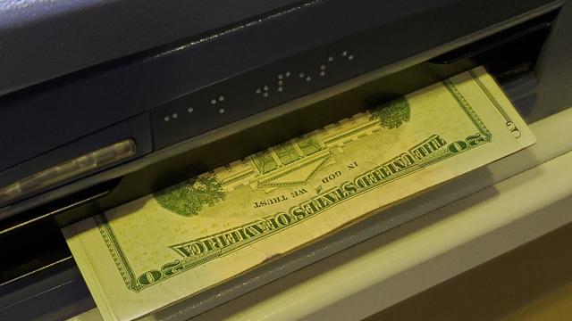 An ATM dispenses cash in San Jose, California, Dec. 18, 2021. 