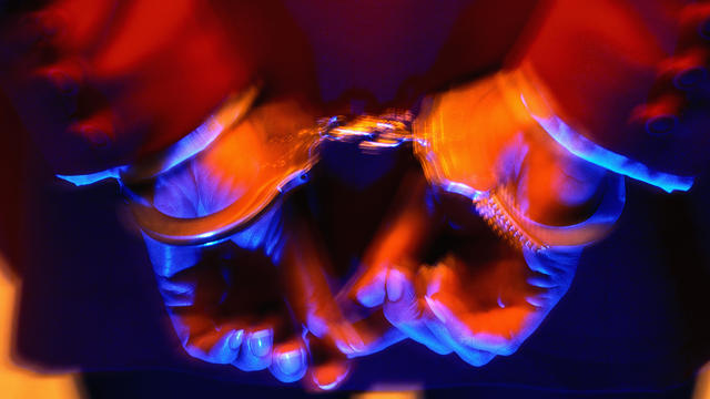 Closeup of woman's hands restrained in handcuffs 