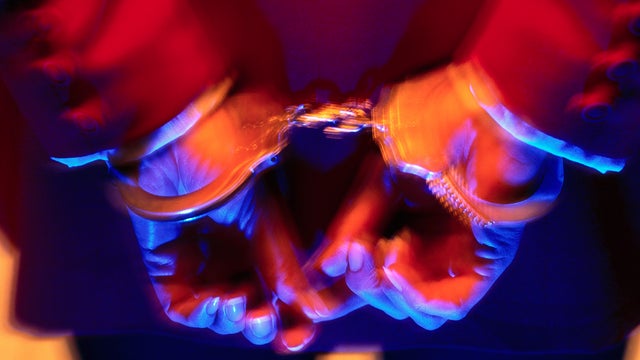 Closeup of woman's hands restrained in handcuffs