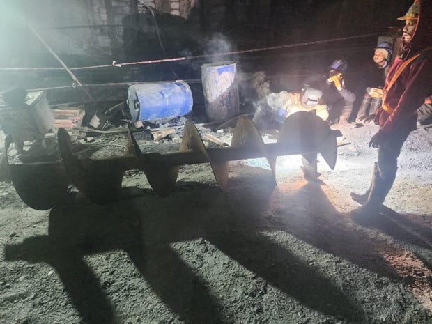 Workers prepare an auger during a rescue operation after a portion of an under-construction tunnel collapsed in the northern state of Uttarakhand, India, Nov. 14, 2023