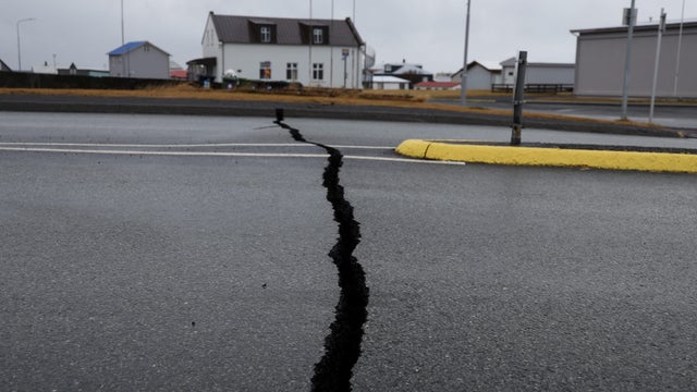Cracks emerge on a road due to volcanic activity near a police station, in Grindavik 