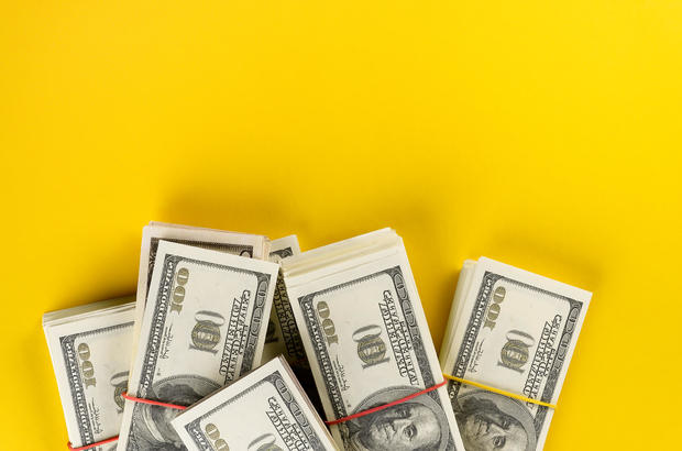 US dollars American Bills in Bundles On a Bright Yellow background. 