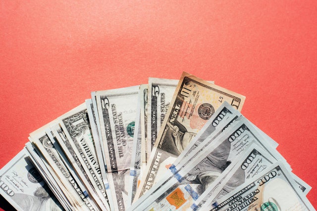 Dollars on a red background. Money. Currency. Inflation. World Crisis. 