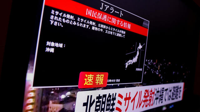 A TV screen displays a warning message after the Japanese government issued an emergency warning for residents of the southern prefecture of Okinawa, saying a missile had been launched from North Korea and that residents should take cover indoors, in Tokyo, Japan, Nov. 21, 2023. 