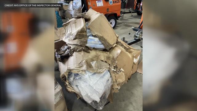 Wet, ruined cardboard boxes filled with PPE. 