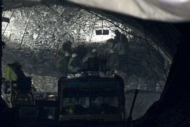 Rescue workers send food through a pipe during rescue operations for trapped constructions workers 10 days after a section of the under construction Silkyara road tunnel collapsed in India's Uttarakhand state, Nov. 21, 2023