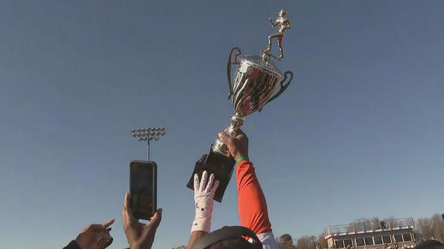 Players hoist the trophy after winning the 2023 Turkey Bowl in Camden. 