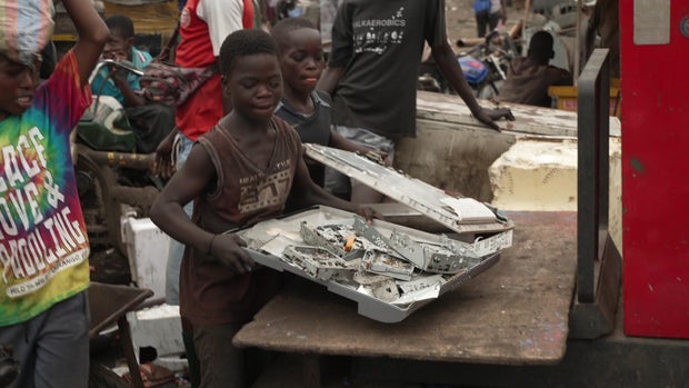 Kids work amid the toxic landfill