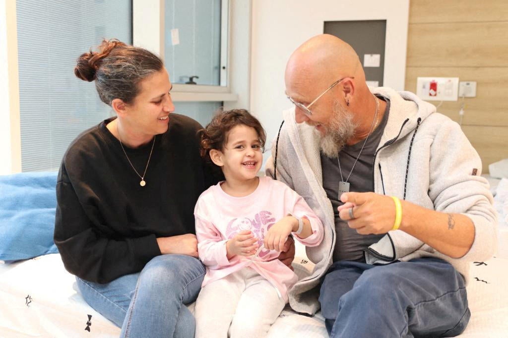 Abigail Edan, who was released after being taken hostage during the October 7 attack by Palestinian militant group Hamas talks with her aunt Liron and uncle Zuli in Petah Tikva 