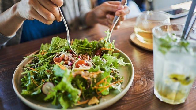 Japanese woman eating a vegan lunch at a vegan cafe