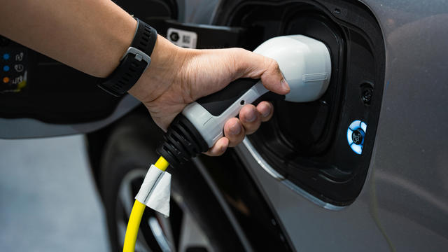 Hand charging modern electric car 