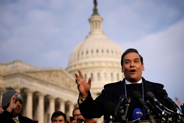 Rep. George Santos talks to reporters outside the Capitol on Nov. 30, 2023.  