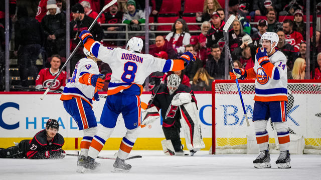 Mathew Barzal #13 of the New York Islanders celebrates with teammates after scoring the game-winning goal in overtime against the Carolina Hurricanes at PNC Arena on November 30, 2023 in Raleigh, North Carolina. 