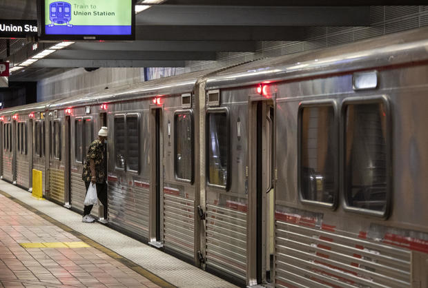 A man hops on a METRO Red Line train 