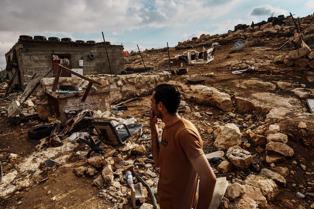 Neighbors of Mohammad Abed inspect Abed's home and farmland damaged by Israeli settlers whom he accused of vandalizing his property, in Shaeb Al-Botum in the West Bank on Nov. 15, 2023.