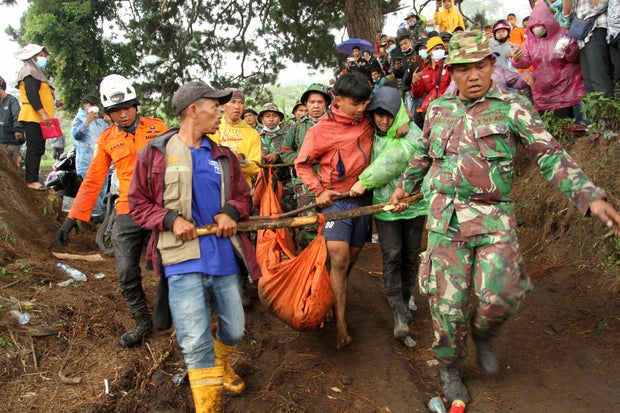 Indonesian rescue teams carry body of Mount Marapi eruption victim in Nagari Batu Plano
