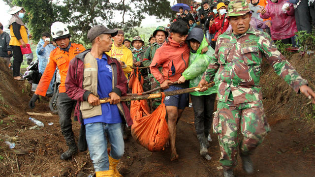 Indonesian rescue teams carry body of Mount Marapi eruption victim in Nagari Batu Plano 