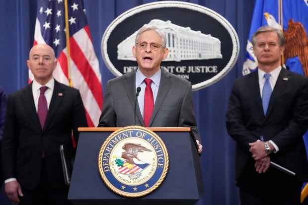 Attorney General Merrick Garland speaks with reporters during a news conference at the Department of Justice on Wednesday, Dec. 6, 2023, as Secretary of Homeland Security Alejandro Mayorkas and FBI Director Christopher Wray look on.