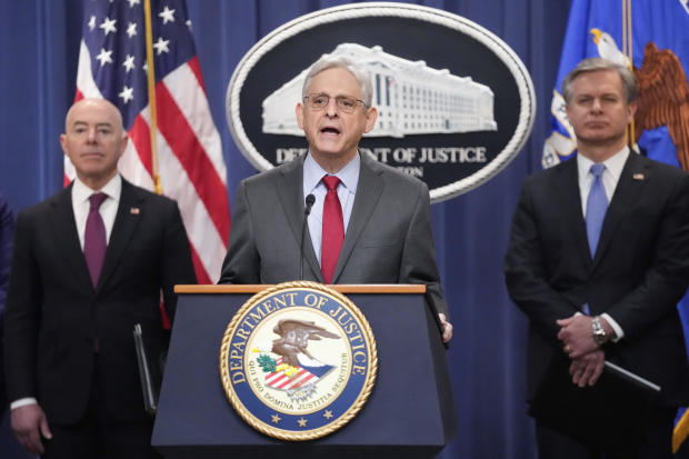 Attorney General Merrick Garland speaks with reporters during a news conference at the Department of Justice on Wednesday, Dec. 6, 2023, as Secretary of Homeland Security Alejandro Mayorkas and FBI Director Christopher Wray look on. 