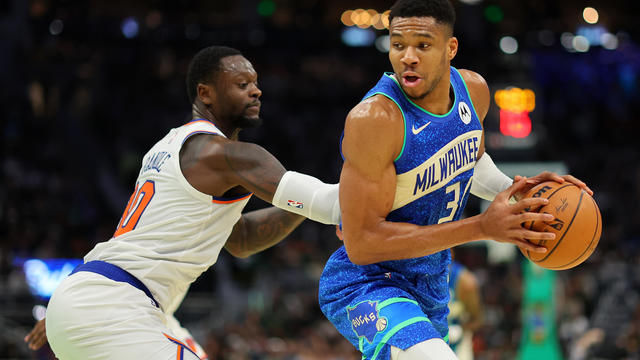 Giannis Antetokounmpo #34 of the Milwaukee Bucks is defended by Julius Randle #30 of the New York Knicks during the first half of the NBA In-Season Tournament Quarterfinal at Fiserv Forum on December 05, 2023 in Milwaukee, Wisconsin. 