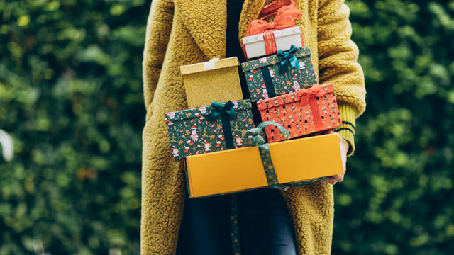Woman holding Christmas gifts. 