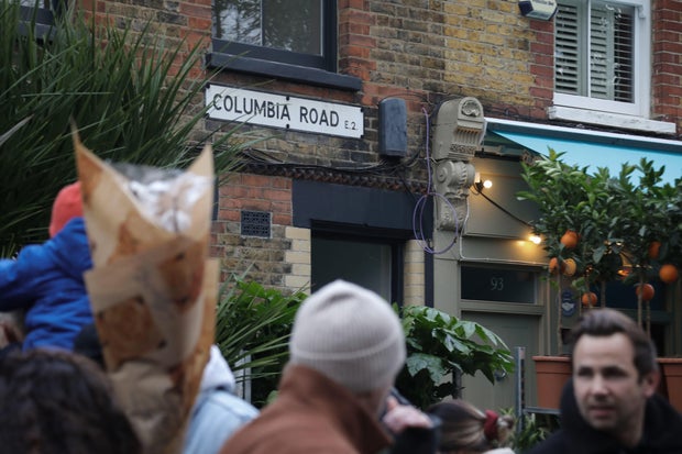 People shop at London's Columbia Road Flower Market on Dec. 6, 2020.